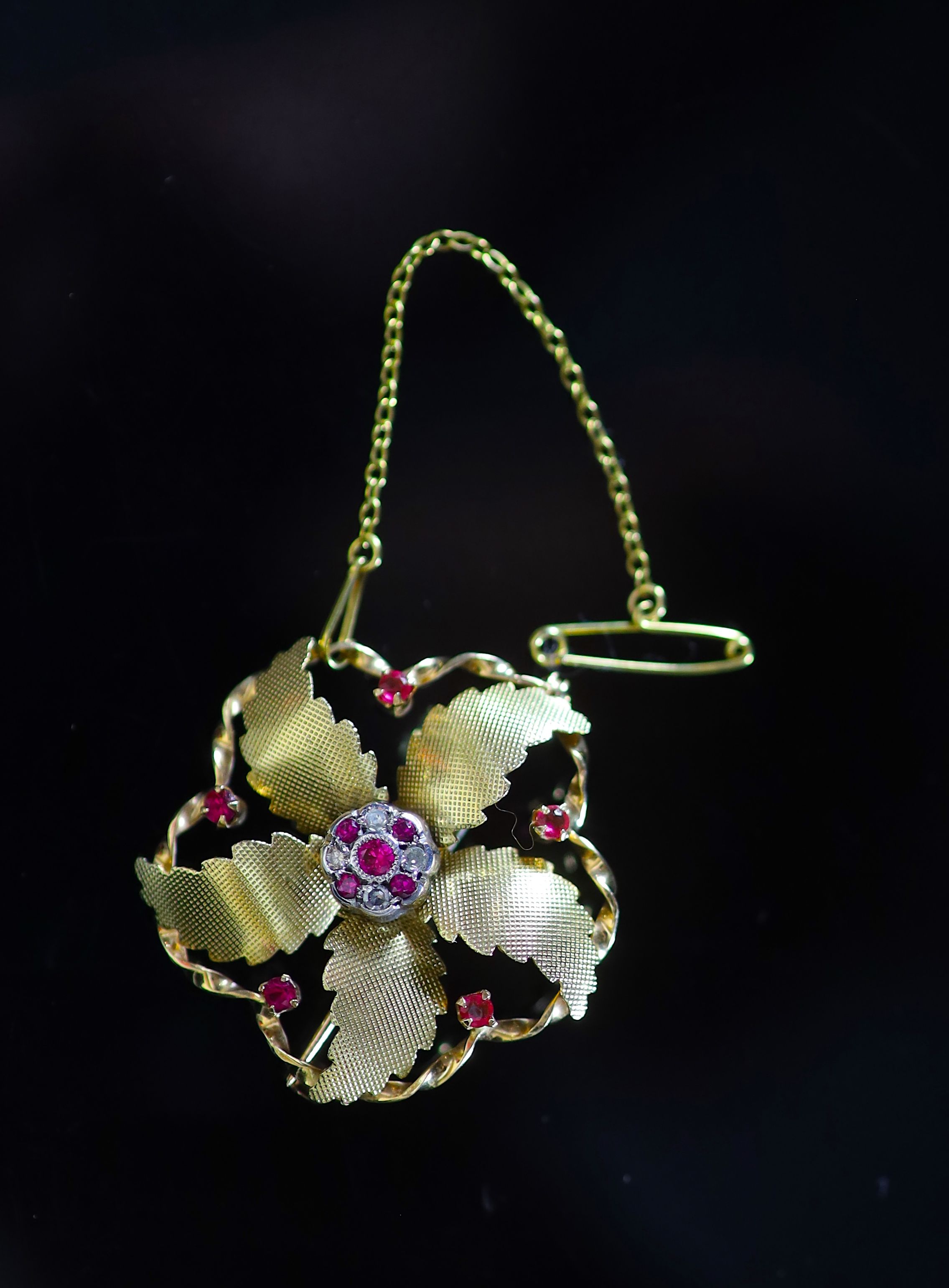 A mid 20th century Italian 18ct gold, ruby and diamond set flower head brooch